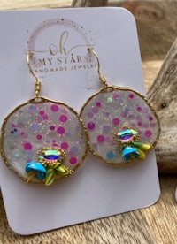 a pair of earrings with pink, blue, and green crystals