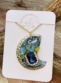 a necklace with a blue flower on it